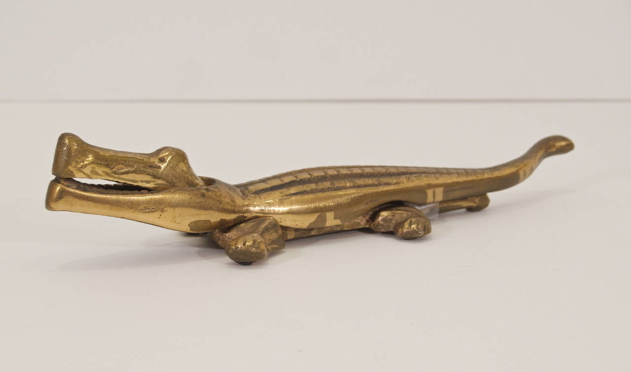 Excellent vintage nutcracker in the form of an alligator. Body of the alligator opens to crack nuts in the jaws.