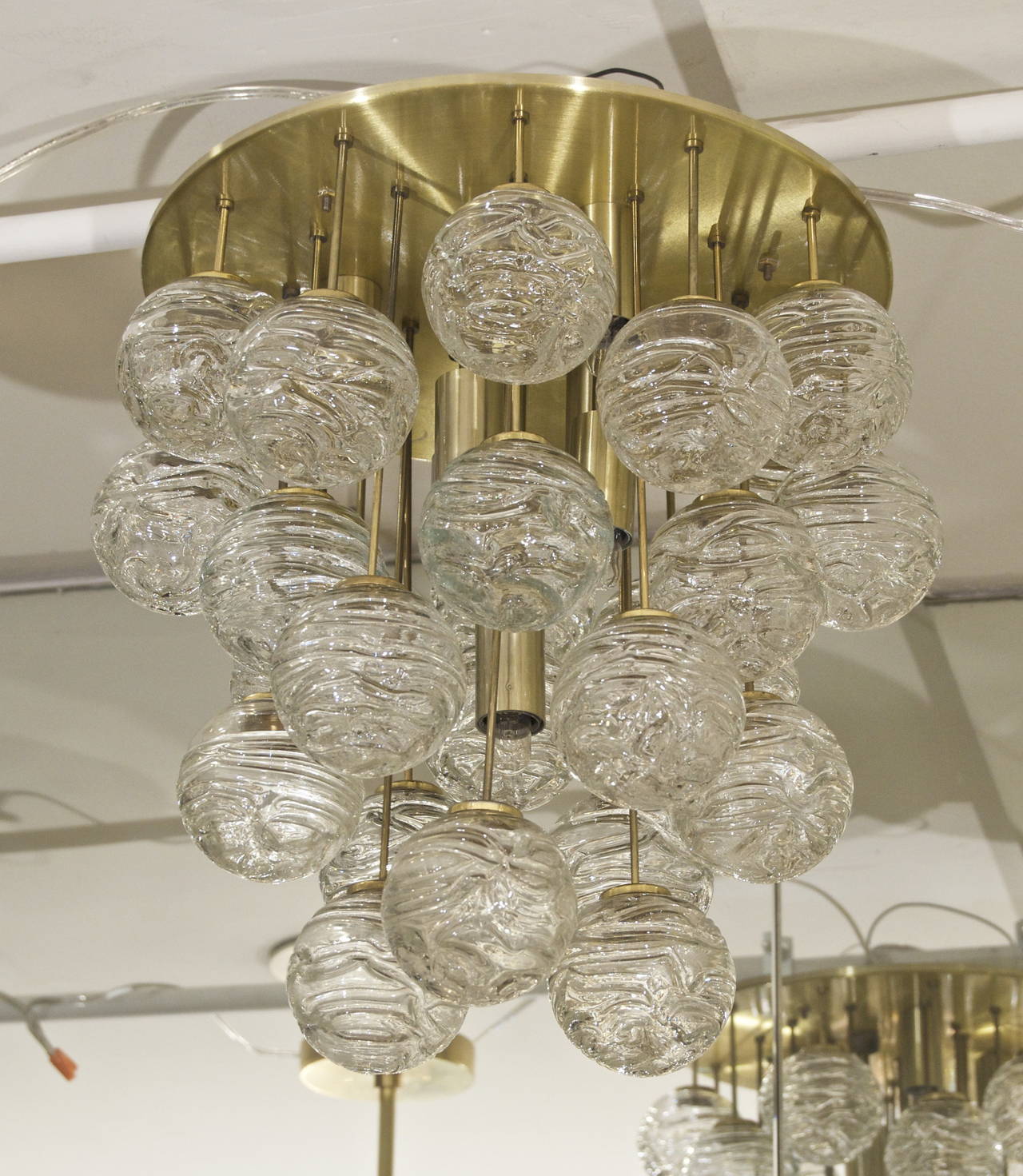 Excellent and rare Doria flush mount chandelier; the central brass light base is surrounded by organic spun glass globes supported by a central brass disc.

Takes seven E-14 base bulbs up to 40 watts per bulb, new wiring.