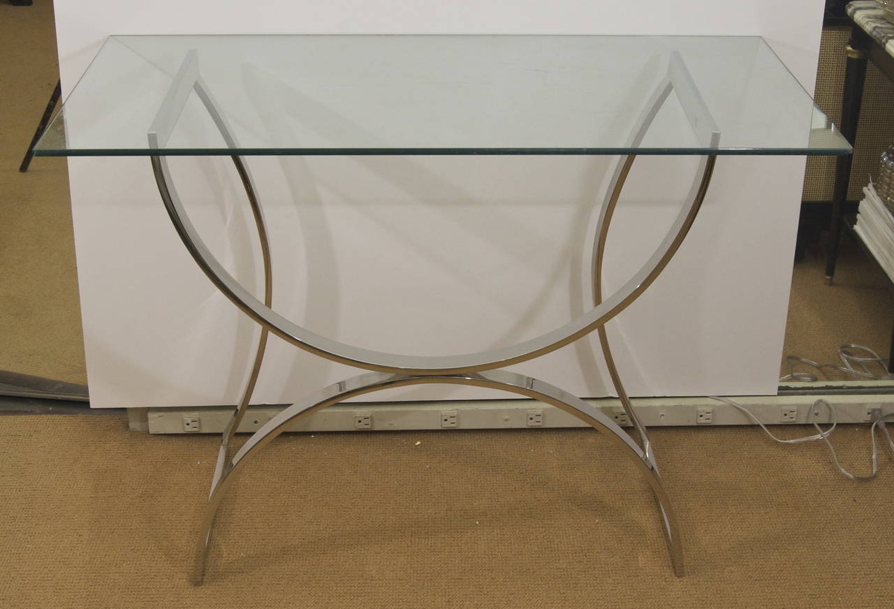 Sculptural chrome table, the arched form base making an elegant console or desk when topped with glass. Also can be used as a square coffee table.

Glass can be cut to measure.