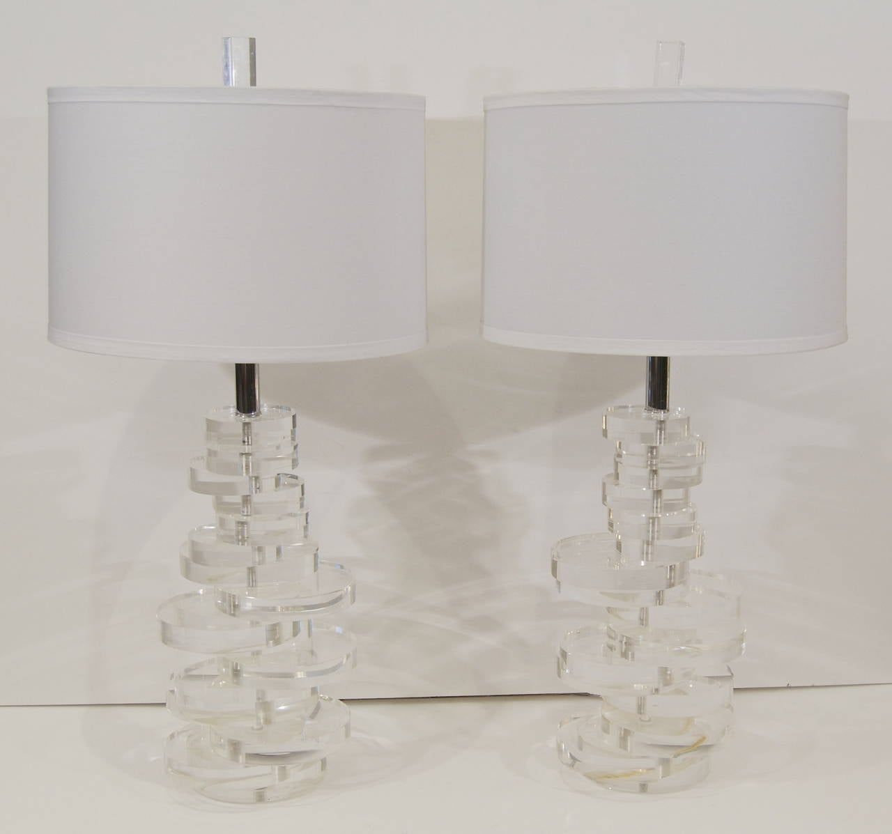 Excellent pair of table lamps of stacked Lucite discs by Marlee. Original finials, chrome hardware. Signed on base.

Three way socket up to 150 watts, new wiring and socket.

Lampshades shown are for demonstration purposes only and are not