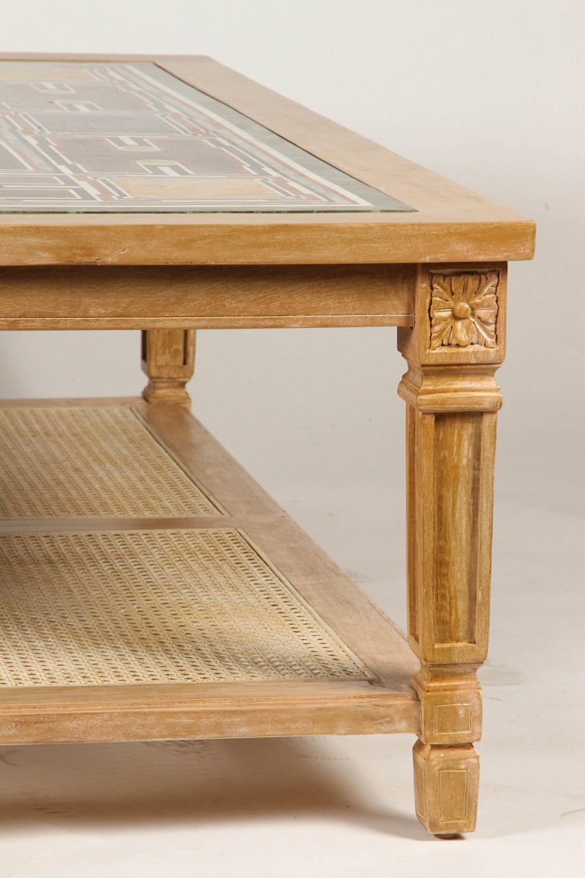 Slightly tapered legs support a cane shelf and an exquisitely inlaid marble top. Classic lines and its ethnically inspired beauty makes this table the perfect balance between craftsmanship and functionality.