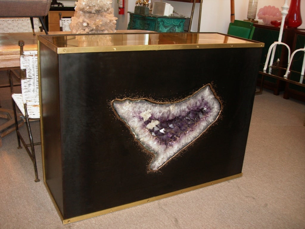 MORE amazing than it looks - this huge deep purple Brazilian amethyst specimen is encrusted within the iron and bronze brutalist detail trims and patinated brass top.  Sits on rolling casters for easier movement (weighs approx. 300 lbs).  Double