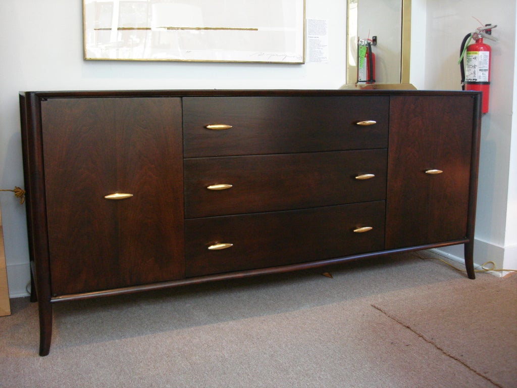 24K Gold plated ceramic hardware w/matte chocolate brown stain. Three large central drawers and lateral shelves to interior.