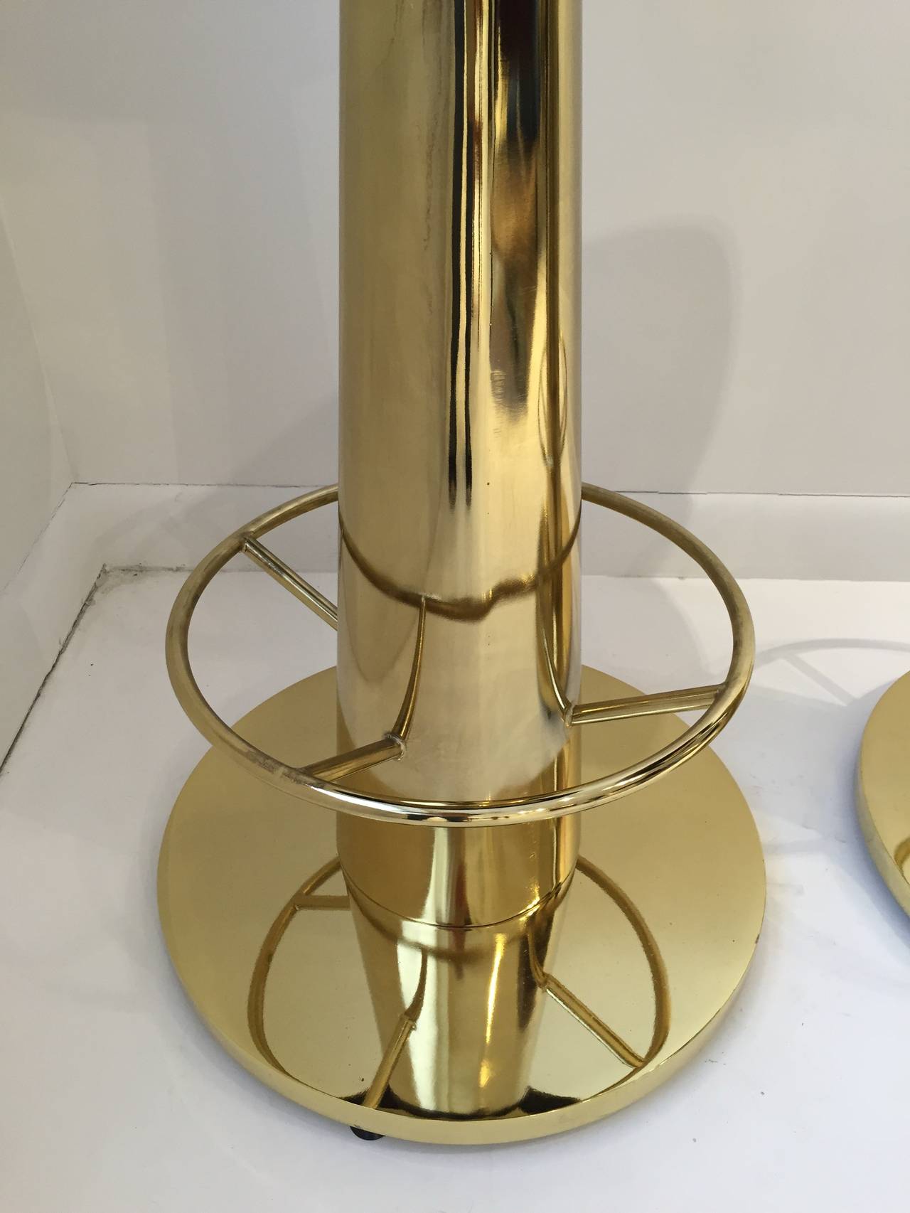 Brown leather seats and high polished brass plate over heavy metal bases. These are stunning and comfortable, originally purchased for the Delano Hotel and keep in storage and un-used by the Hotel.

Dimensions: 31.5 seat height, 14.5 diameter