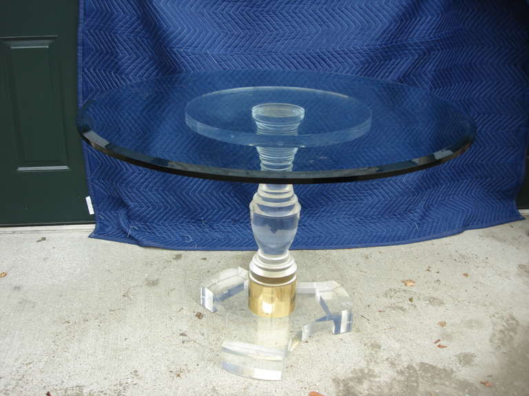 Rare Lucite pedestal table with beautiful clairity and brass strap detail.  Beveled glass round top.

Dimensions of BASE ONLY:  28 height, 20 diameter