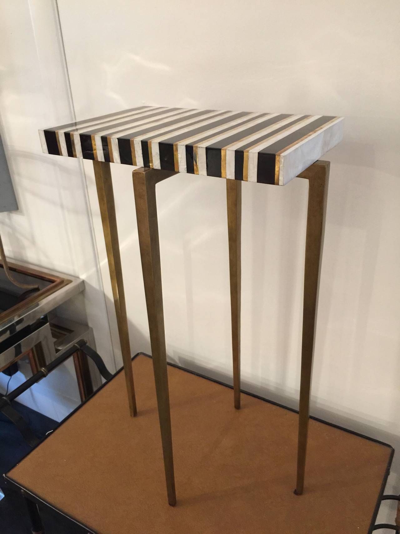 Petite stylish accent piece with tapered gilt metal legs. Beautiful little occasional table.
