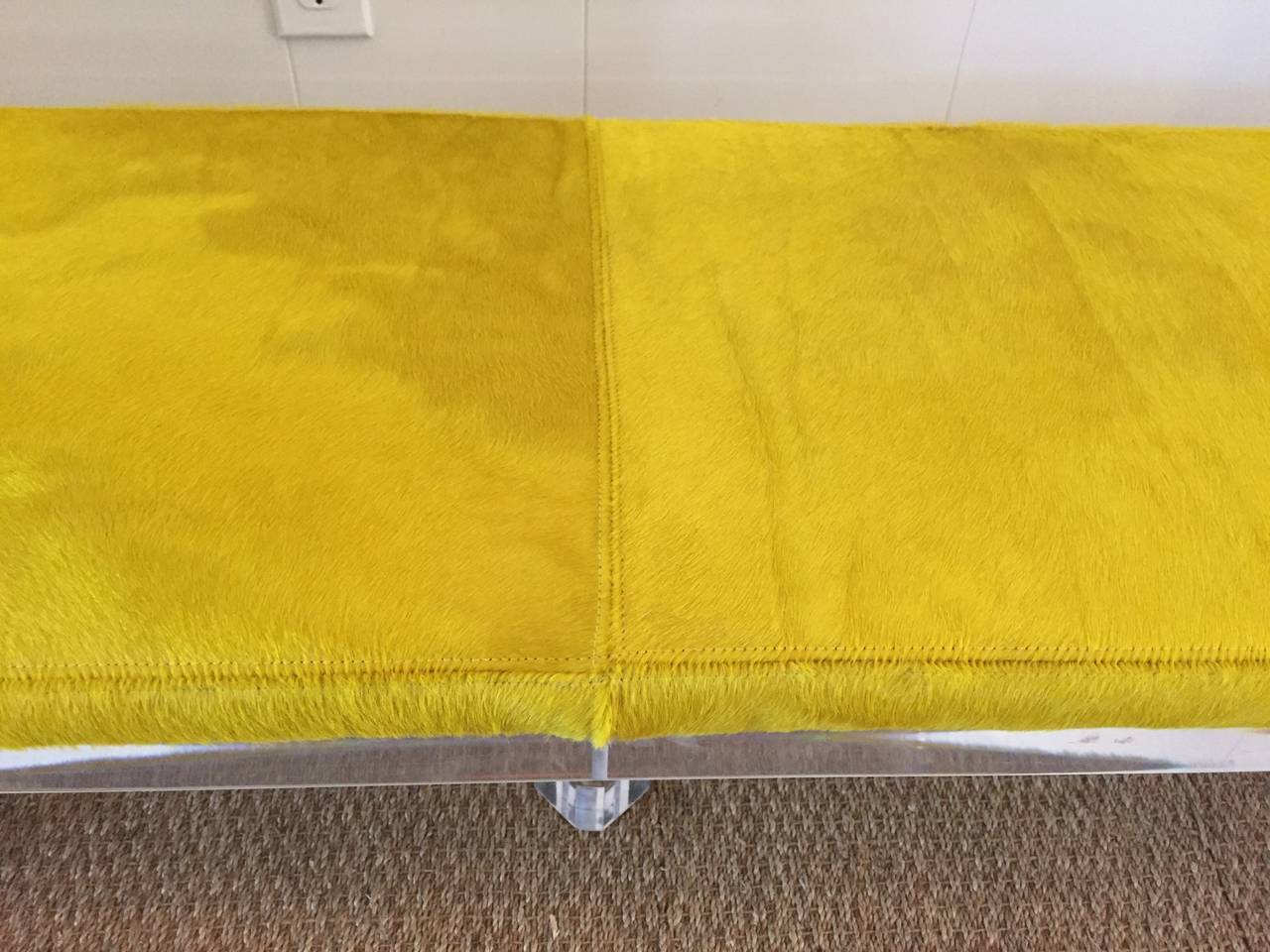 A beautiful five-leg thick lucite bench with canary yellow cowhide.  See detail images for the full effect and beauty.