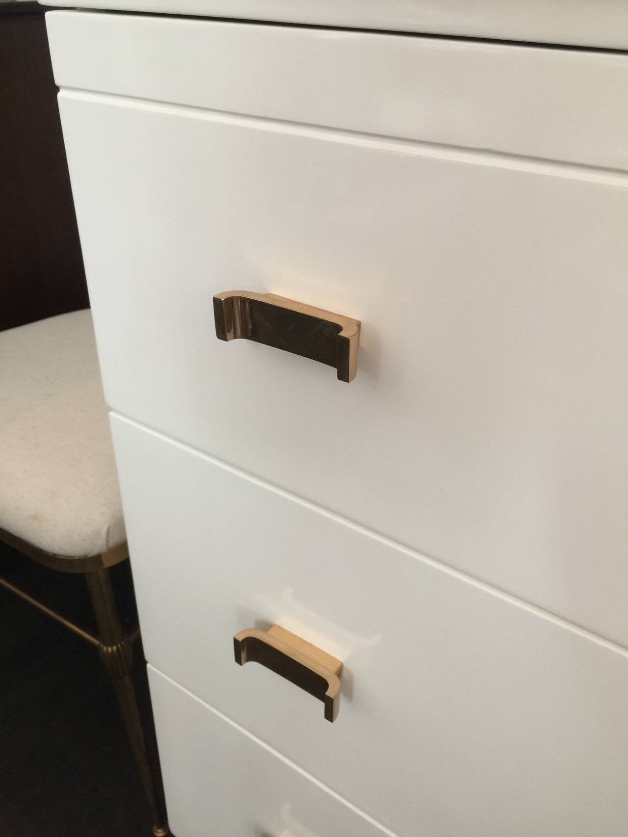 Manufactured and labelled by Amodec, this important Art Deco piece displays simple lines and elegant and original bronze hardware. Original ivory lacquer.