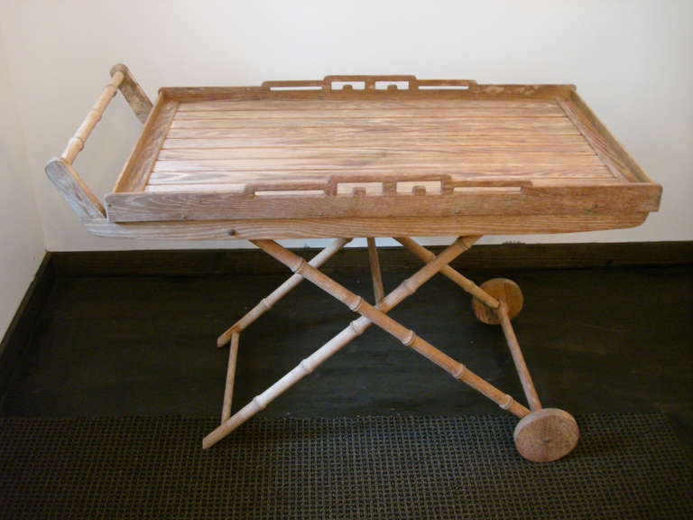 Oversized tray table on fixed wheels with faux bamboo cart handle and decorative side detail.  Perfect as a side table, drinks cart, serving table or occasional piece.
