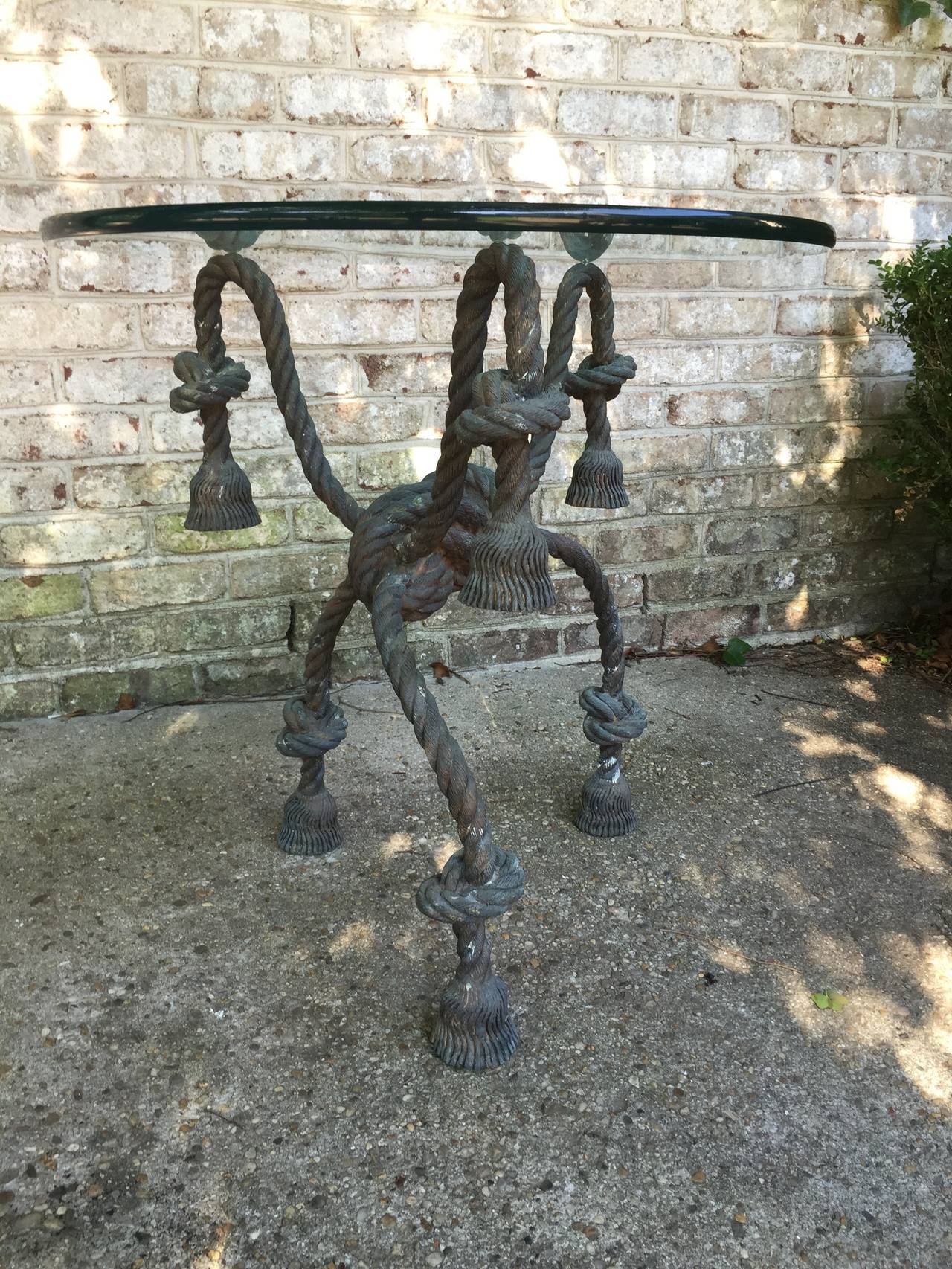 Three legs and very realistic and ornate, this patinated bronze rope and tassel-like table base has beautiful proportion.
