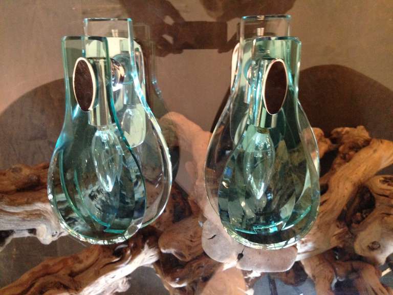 Gorgeous pair of green faceted glass sconces rewired for US standards. Each sconce can take 25W (recommended) to a maximum of 40W.  Faceting provides beautiful illumination.