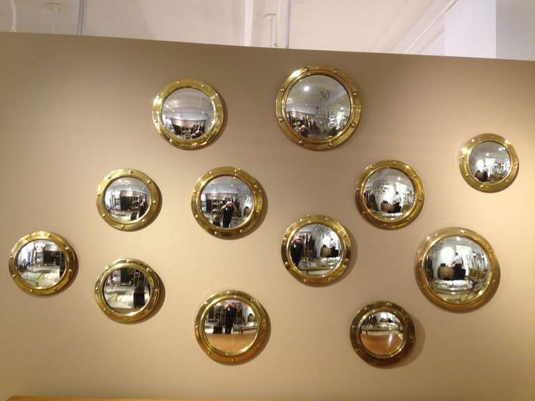 Massive collection of brass patinated frame convex mirrors.  

Dimensions: large - 14.25 inches diam
Medium - 12 inches diam
Small - 10.25 inches diam
