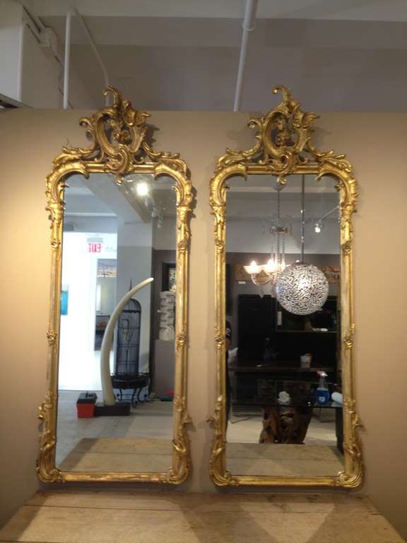 Splendid pair of all gilded plaster wall mirrors.

     
     