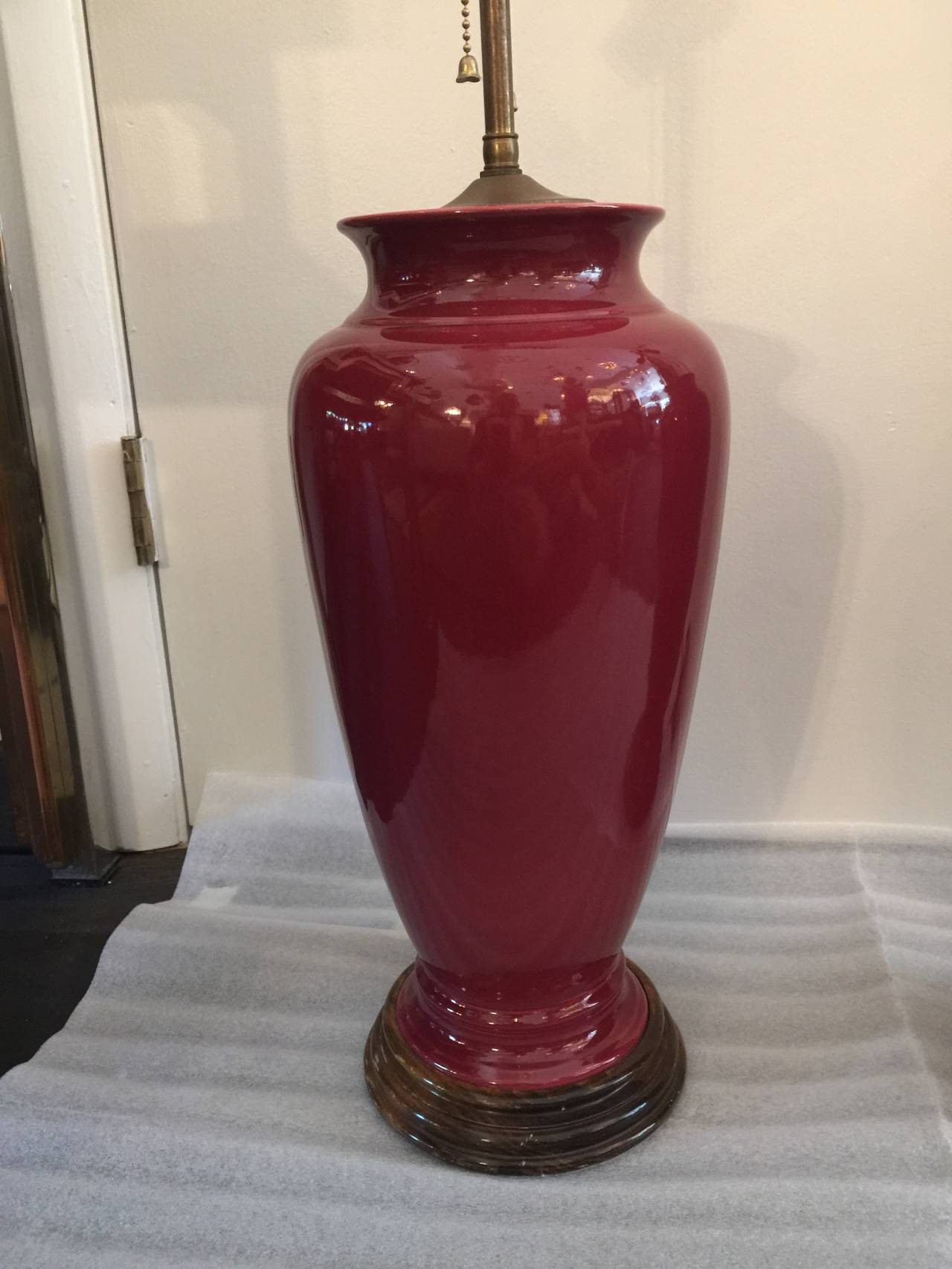 All original, these oxblood toned lamps with mahogany bases and double light sockets are in extremely well preserved vintage condition.