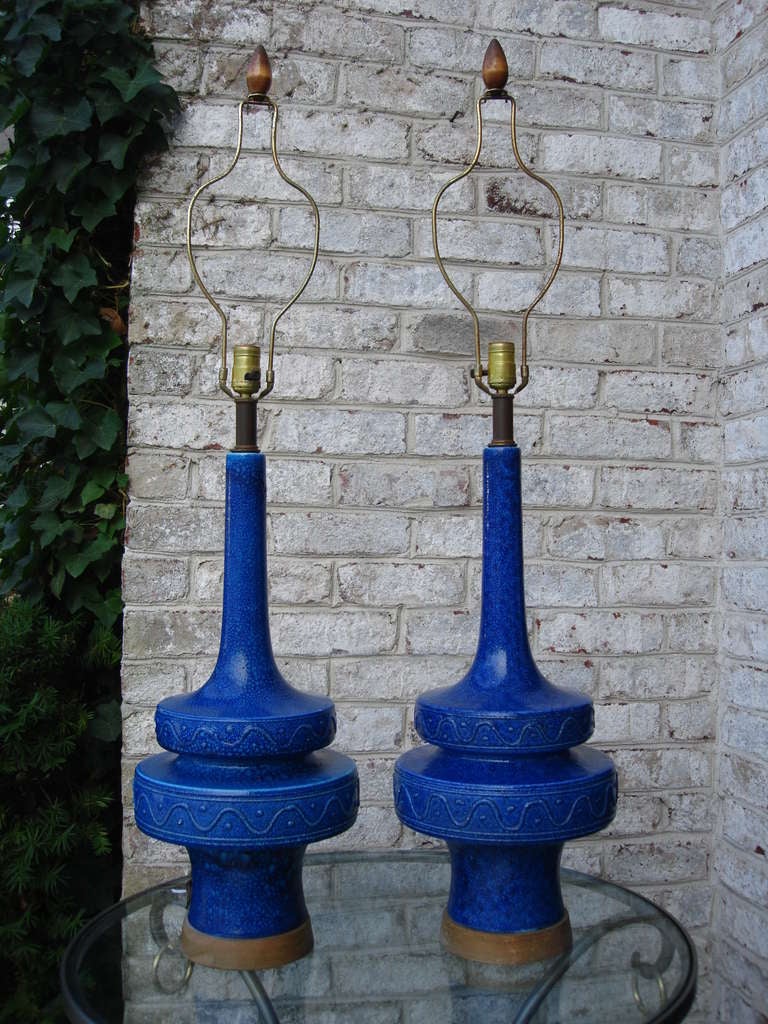 Beautiful pair of tall ceramic blue lamps on wood base.