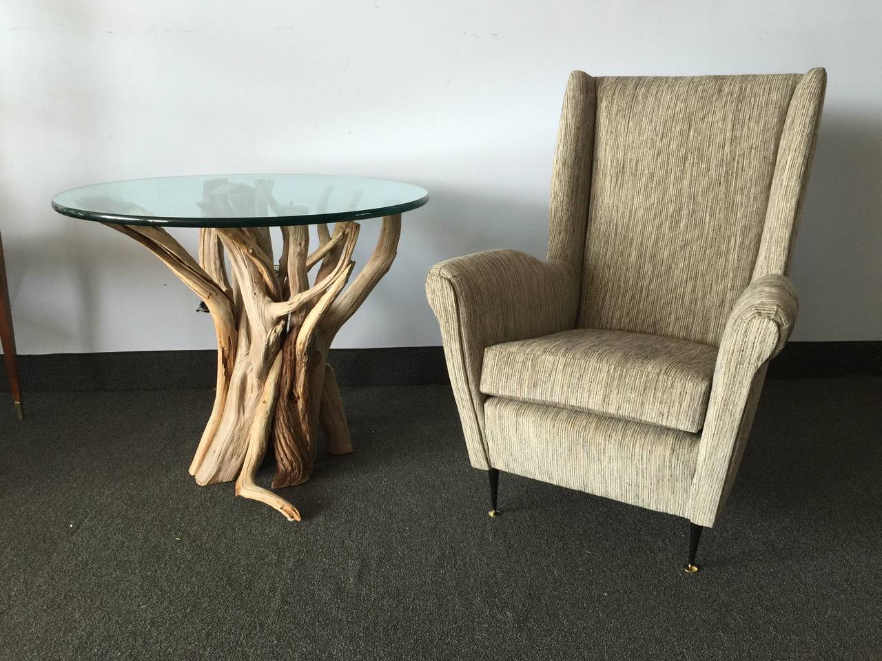 Made from driftwood branches, this free flowing organic table base is topped by a 3/4 inch round edged green glass.