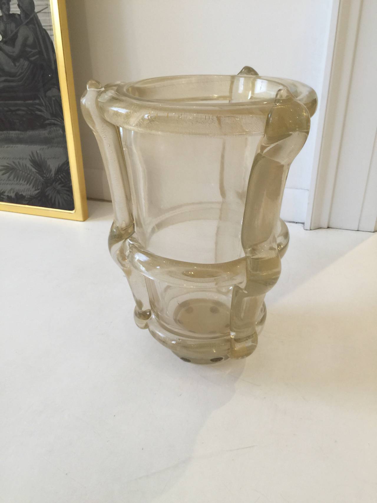 This signed vase is hand blown with gold flake and glass.