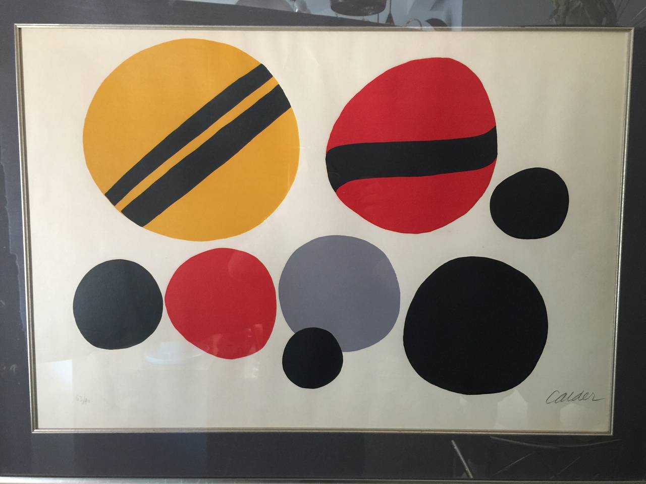 Chevrons Noir sur Rouge et Jaune, 1960, lithograph in colors by Alexander Calder (1898-1976) pencil signed and numbered 63/90. Dimensions for print only are as follows: 25 inches H x 35 inches W.

See detailed images for documentation from the