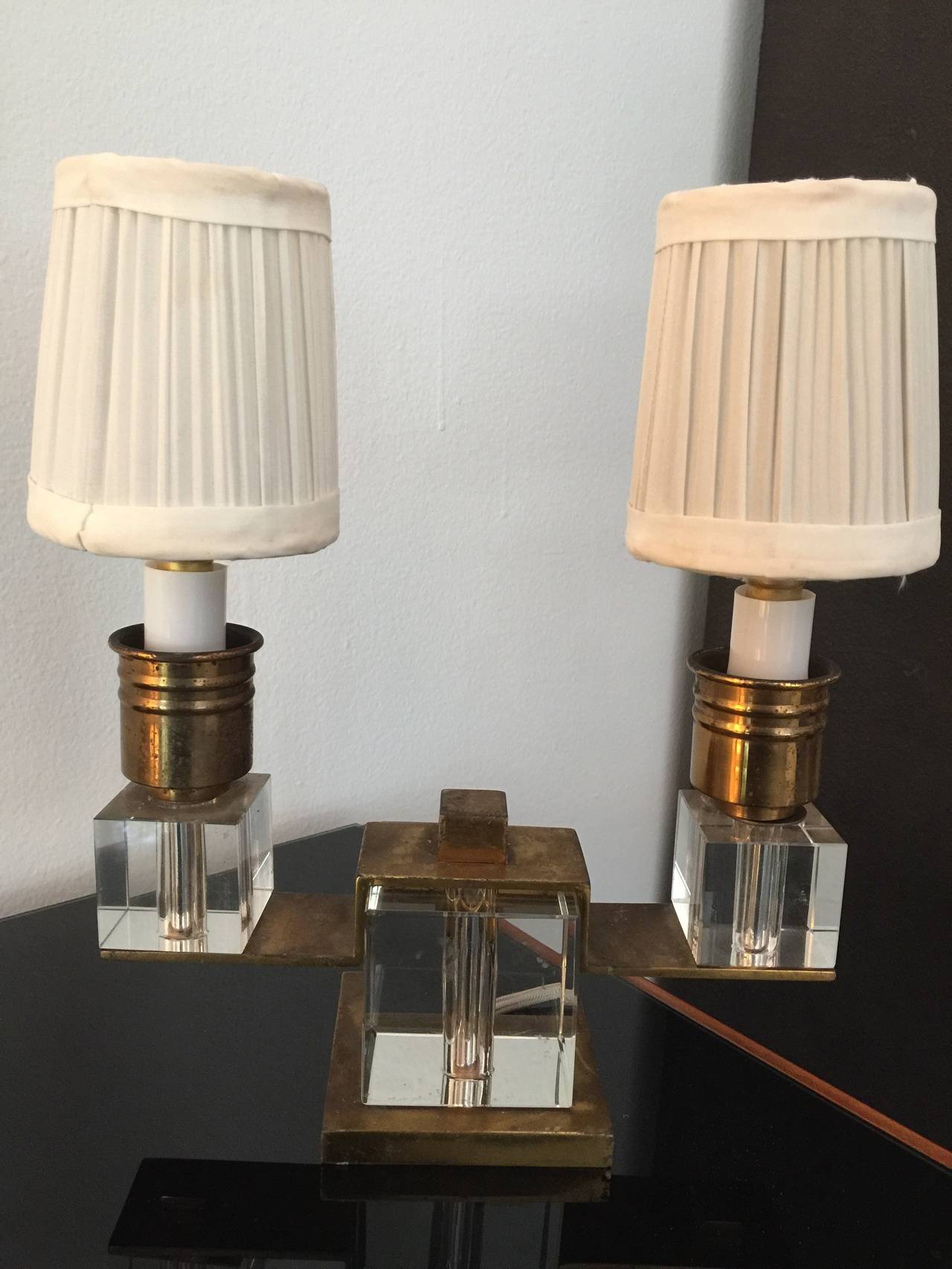 Exquisite petite two-light boudoir lamp in perfect working condition with silk cord. Composed of three crystal blocks encased in patinated dore bronze hardware. All original with dark patination which enhances the beauty of the piece. A jewel.