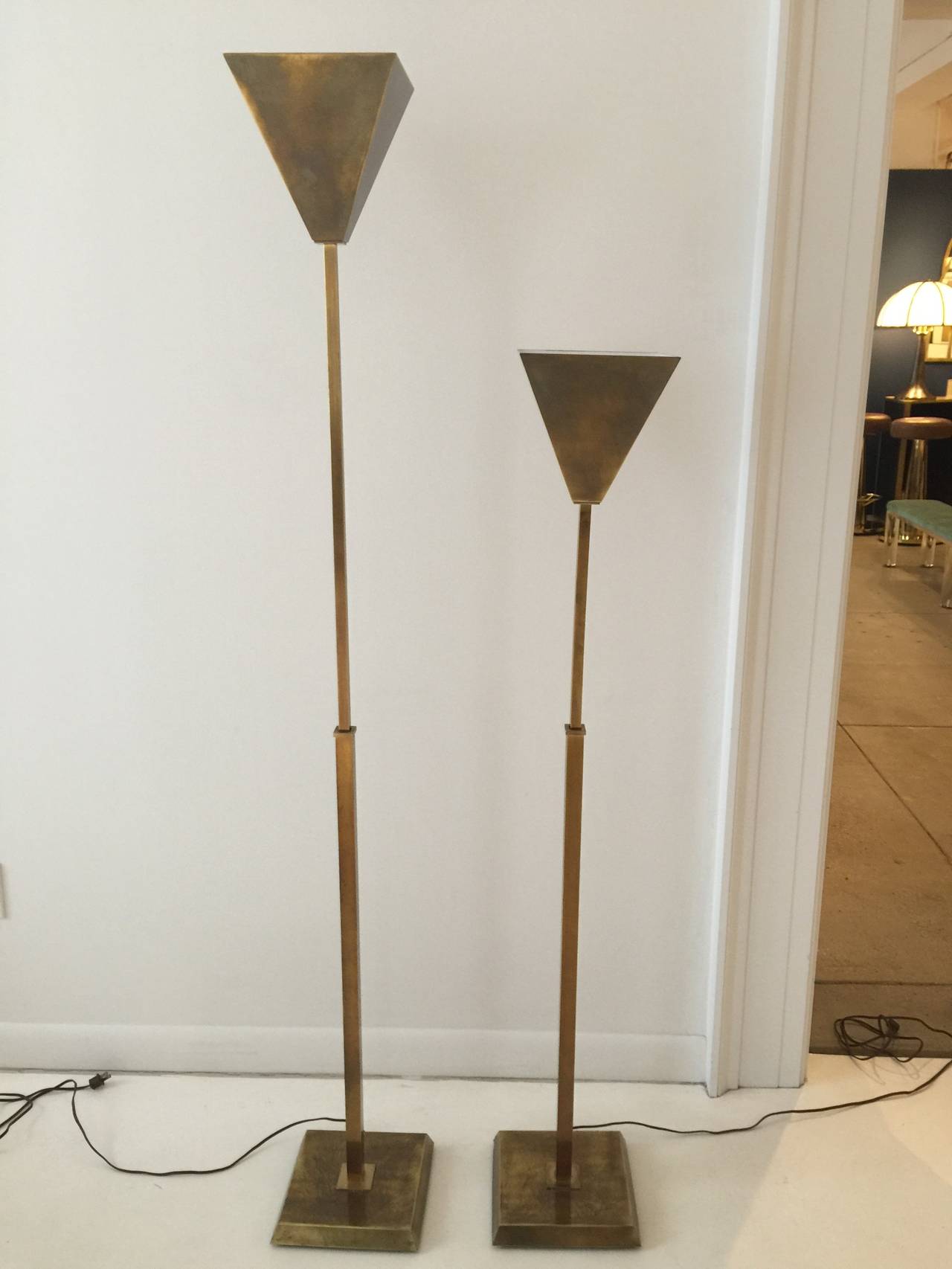 A wonderful original pair of floor lamps with an inverted pyramidal diffuser raised on a chamfered square brass base. These lamps are FULLY adjustable (see detail image).  An integral three-way switch controls the light levels through tapping the