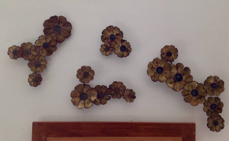 Four unique sculptures in in torch cut brass flowers motif. Can be hung in many variations to wall. Dimensions of largest 21 inches long, 10 inches tall. Smallest is 8 inches in diameter.
 
 