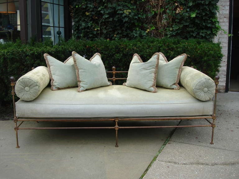 19th Century neoclassical English daybed in heavy iron with ball finials.  Original upholstery in usable condition but best to reupholster.  Original steel springs to underside.