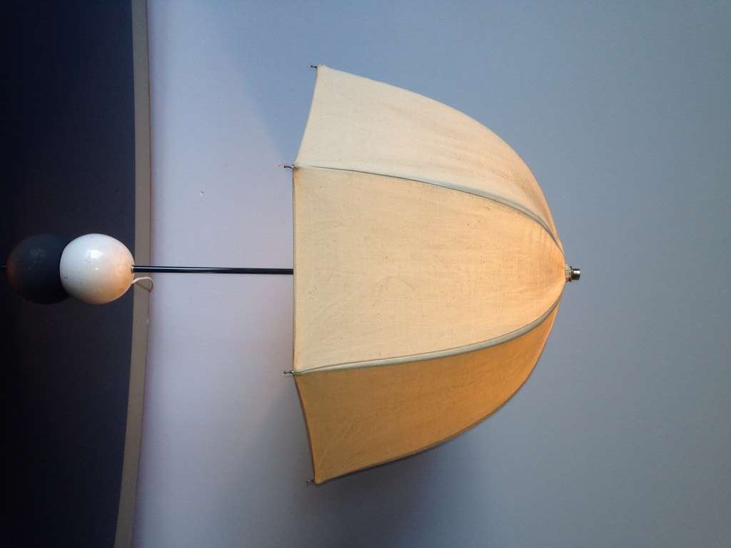 A modern take of a parasol umbrella, this canvas shade on heavy stand is a fun accent to any décor.