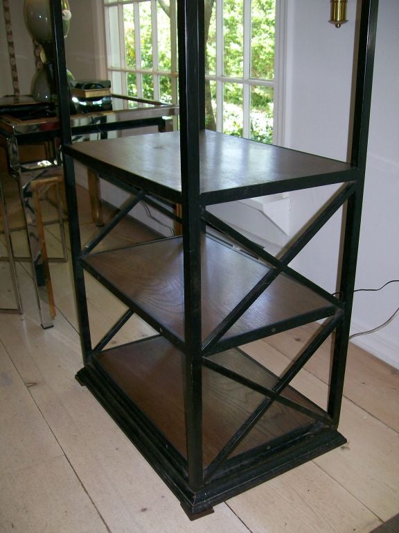 Very heavy and well crafted, this iron and wood ètagerè features X-frame sides. This is very tall, approximately 8 feet and in wonderful original vintage condition.