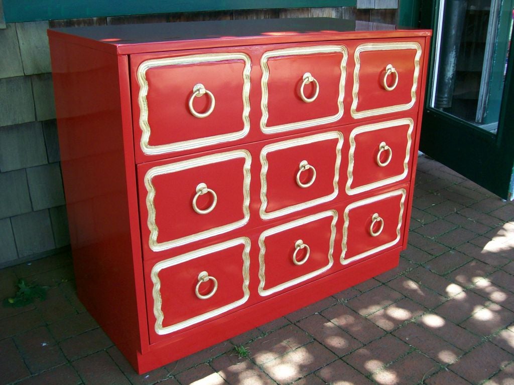 Exceptional 3 drawer Red lacquer dresser with carved, gold leaf detail and pulls.