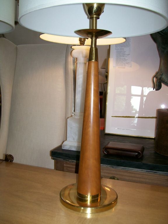Conical candlestick design table lamp tapering to a brass disc. In wonderful vintage condition. Frosted glass diffuser and labeled.

Shades not included.