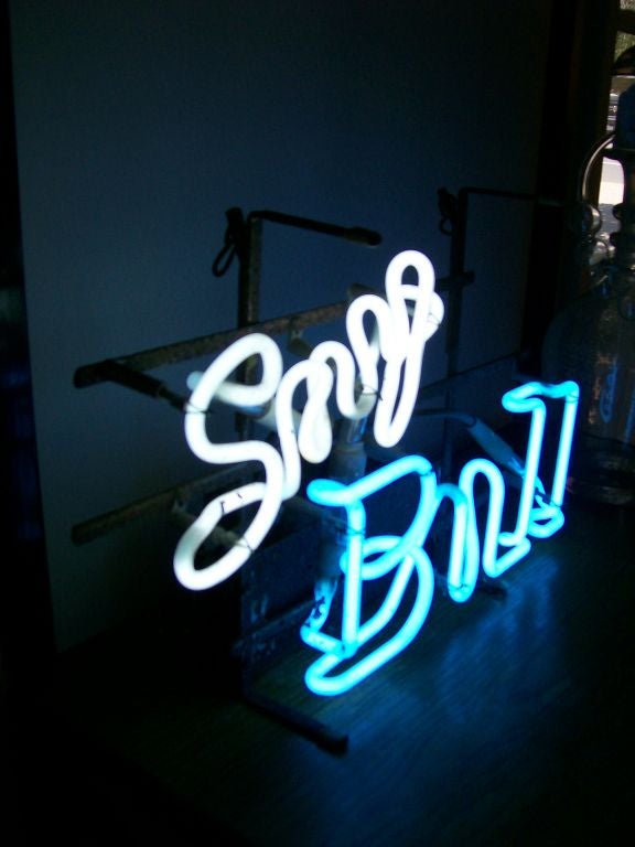 This is a vintage advertising neon sign in white and blue, working great and truly a fun and whimsical piece.  PERFECT for a Wall Street 