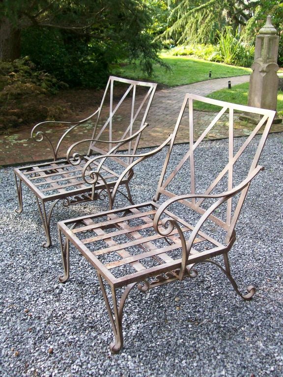 Lattice backrest, scrolled feet and flourishes in iron throughout. These a part of a SET which are being sold separately (two chaises longues, two armchairs and two side tables).