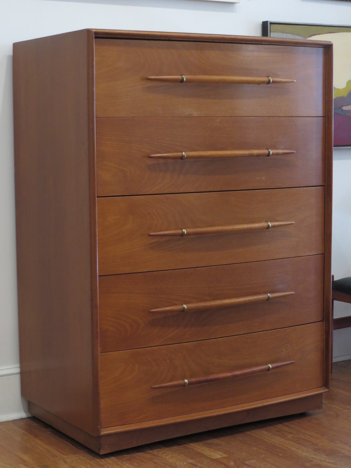 1950s five-drawer walnut dresser, designed by T.H. Robsjohn-Gibbings for Widdicomb. The tusk shaped pulls, anchored by brass mounts, are a rare variation for Gibbings. The wood grain and patina are beautiful. Maker signed.