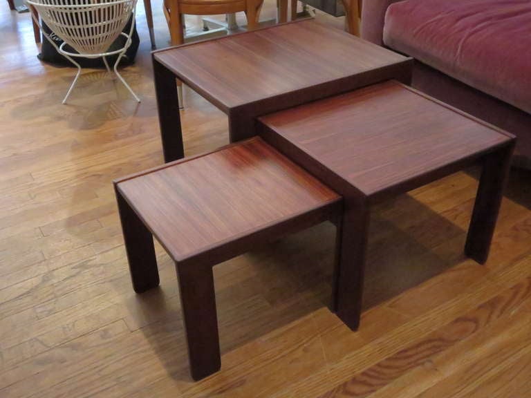 Very sculptural nest of tables in beautiful rosewood..
Largest table is 24d x 20w x 17.5h , medium  19.75d x 18.5 w x 15.5 h, 
smallest: 18w x 14d x 13.5h.