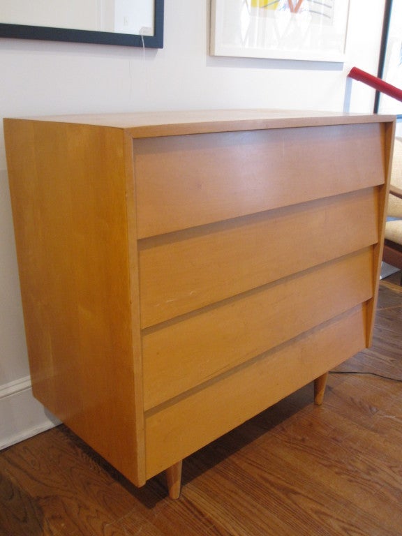 Four drawer dresser designed by Florence Knoll for Knoll.  Solid maple with iconic absence of hardware.   Dresser offers generous storage.  Two available.