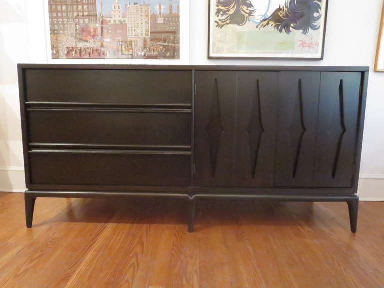 Recently refinished in an ebony finish, this credenza has ample storage.