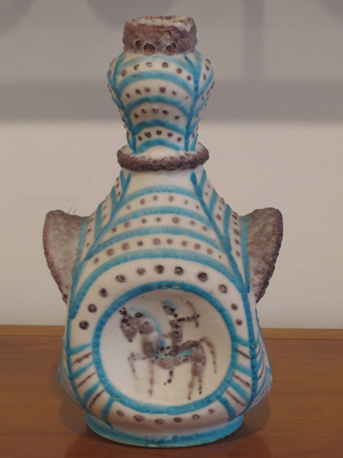 Hand thrown vase by Guido Gambone with turquoise and brown designs on white glaze.