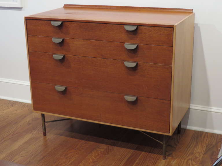 Cabinet / dresser designed by Finn Juhl for Baker.  Finn Juhl's use of different wood tones and metal legs, add great appeal.