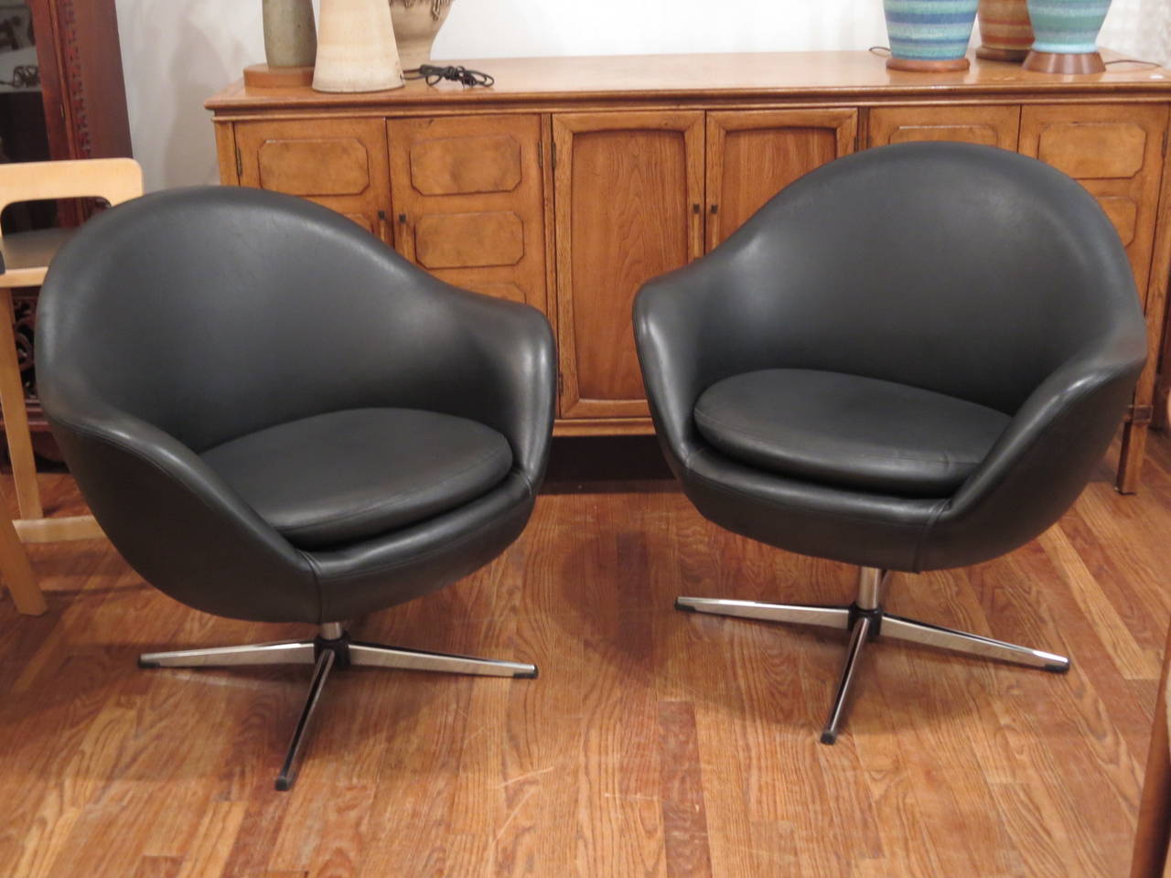 Classic pair of 1960's swivel tub chairs by Overman in very good condition.  The base is aluminum.  The chairs are comfortable and great for residential or office use.