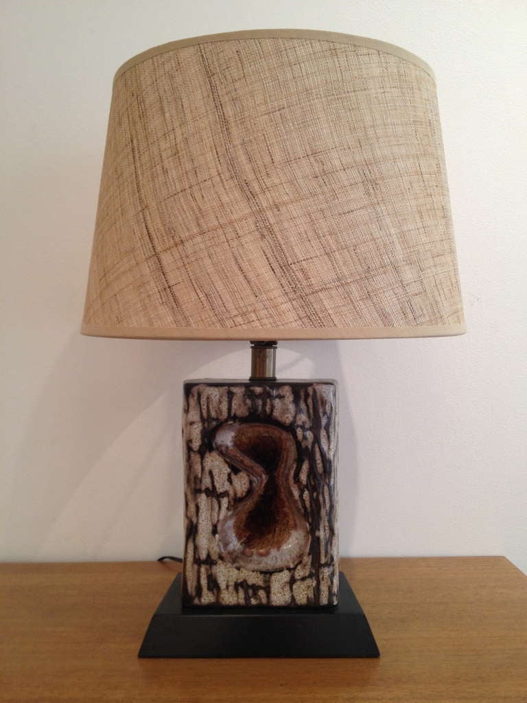 Very appealing studio ceramic table lamp with unusual glazing and crackle affect.  Rests on period wood base with new linen shade.