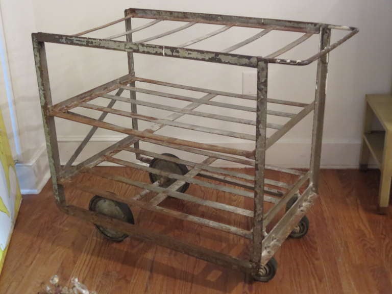 Industrial iron cart ( two available ) can be used in a retail setting for display.  Add wood or glass and can be used in a kitchen for prep,  dining room for serving.  On wheels, so very easy to move around.
It's distressed look, with paint loss,