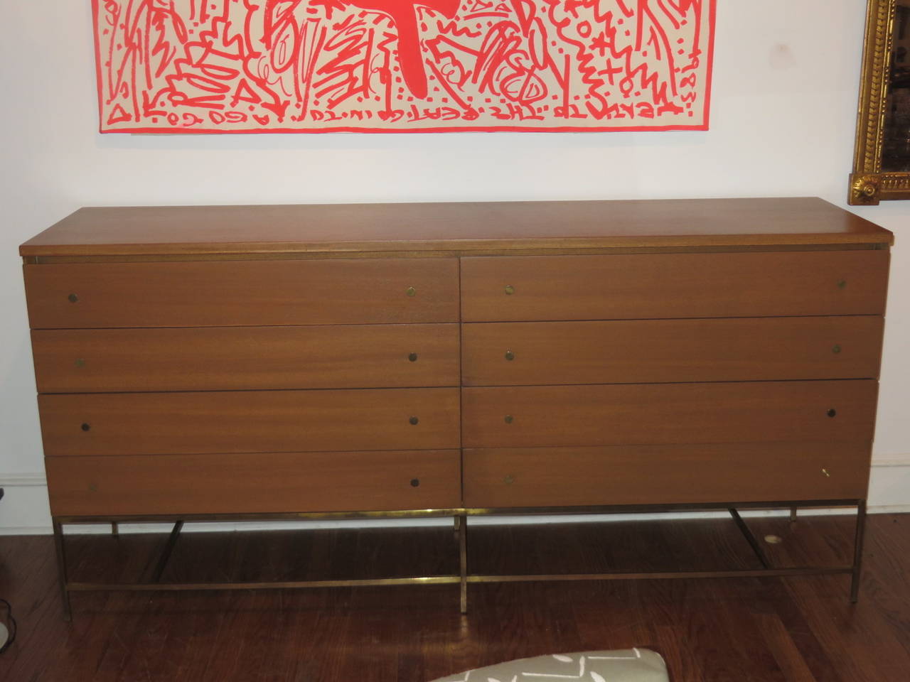1950s Paul McCobb eight-drawer, bleached mahogany dresser on brass stretcher, recently restored. Paul McCobb's design is refined and sophisticated, with his use of brass detail and wood choice.