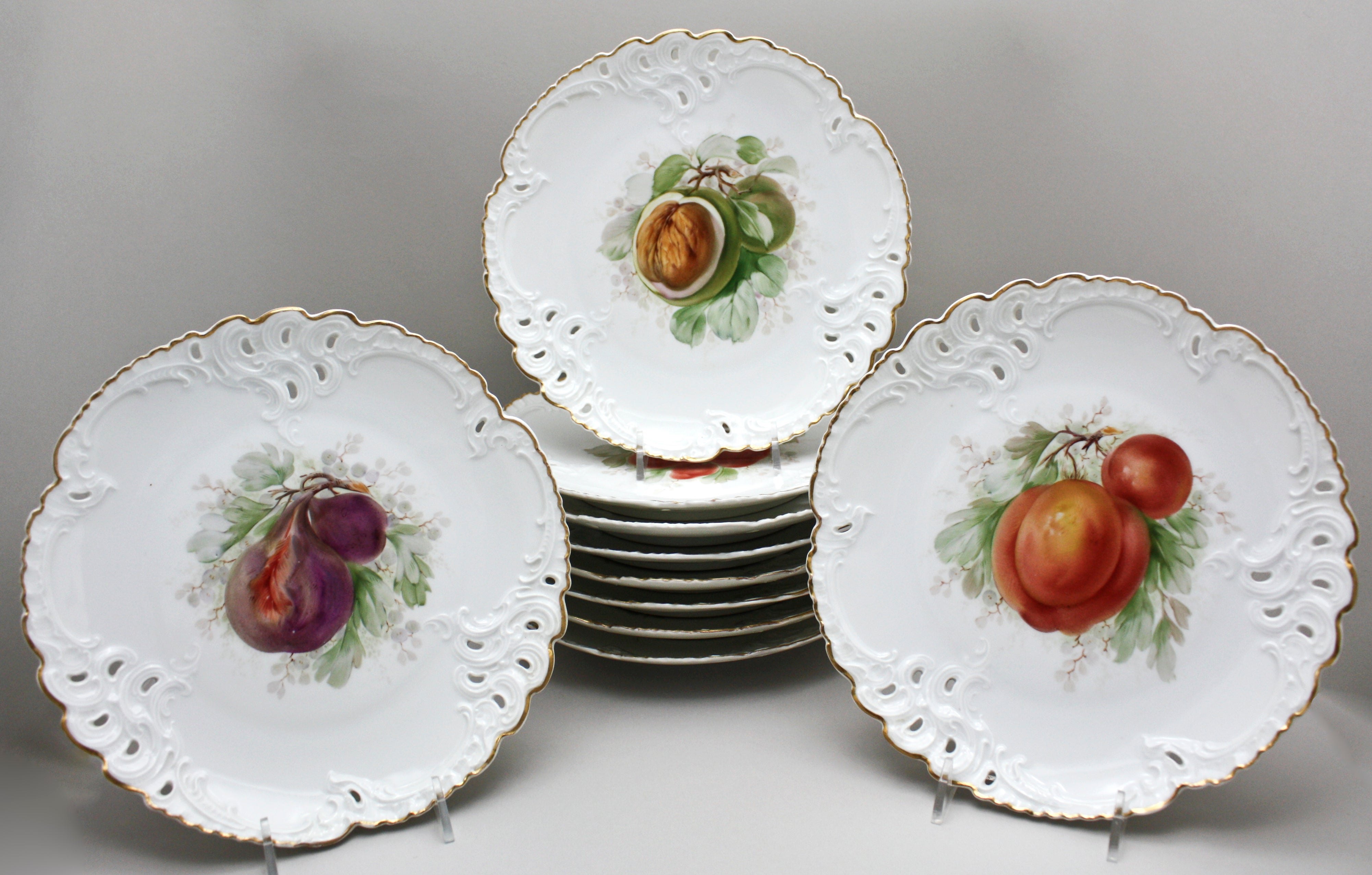 Ten Nymphenburg Hand-Painted Fruit Plates with Molded and Pierced Borders