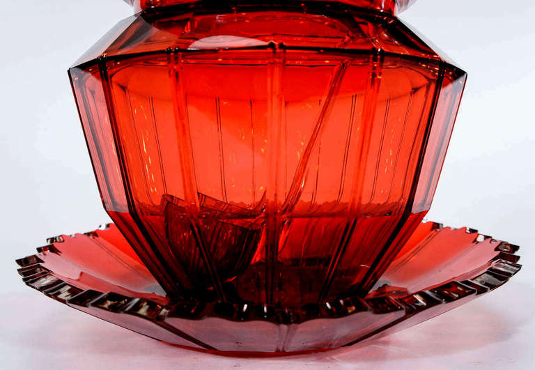 This large and beautifully cut 19th c. punchbowl is cranberry cased in clear crystal with elaborately cut and notched borders. The clear casing is very fine and subtle and can be seen at angles of light on the borders.The matching ladle exemplifies