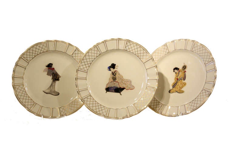 An amazing set of 12 dessert plates with different hand colored characters depicted on each plate, from Samurai warriors to beautiful delicate Geishas. The shaped rims and geometric gold enamel decoration frame the central motifs in a restrained and