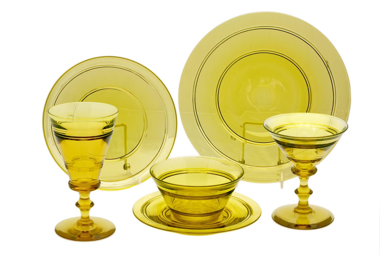This is an amazingly complete and perfect service for 12 made by Steuben. The hand blown topaz crystal is solid in the hand, all with polished pontils and projects the clean lines of the Art Deco period. The set includes 12 dinner plates (10"
