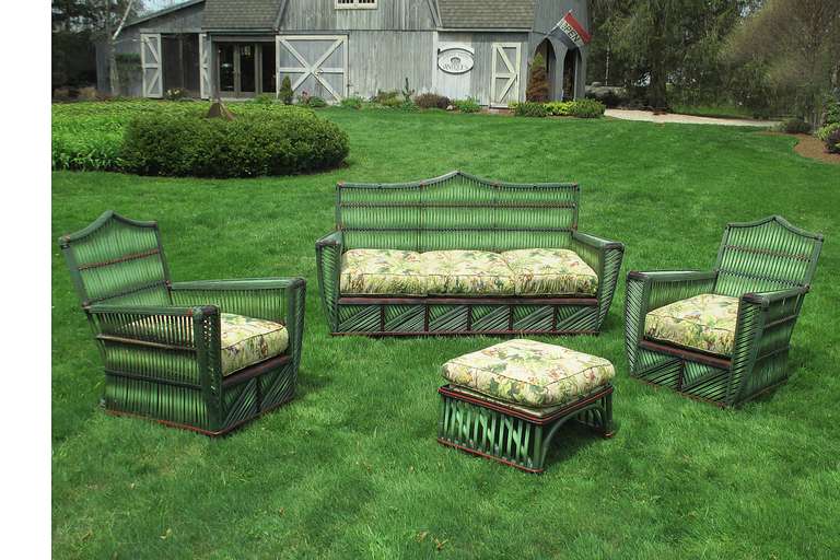 Four-piece Stick Wicker set in duo-toned green glazed finish with decorative fading and black & red painted trim.  Art Deco lines to overall form having bold geometric features including reverse diagonal reeds on front skirts.  Deep seated & wide
