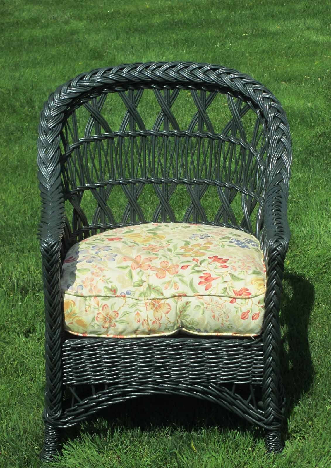Bar Harbor wicker armchair in dark green painted finish. Classic rounded back with triple-X design, also known as Cape May style. Woven seat platform with newer plush cushion. Pineapple twist-wrapped front feet.