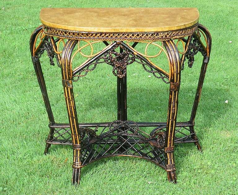Early antique wicker demi-lune table attributed to the Samuel Colt Willow-Ware Factory in Hartford CT.  Hand woven of various sized & colored willow osiers.  Grand cabriole legs and blunt feet connected by an elaborate curved wicker stretcher with