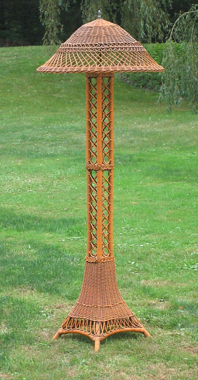 Bar Harbor wicker floor lamp referred to as the Eiffel Tower form. Large scale, standing 6' tall and having a 30